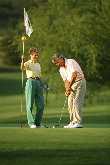 PlatinumPlus citizens Connie and Russell Brodhagen of Del Mar, CA, enjoy a round of golf in a members-only, walled-in golfing facility in East Los Angeles, undisturbed by the surrounding war zone of urban poverty.